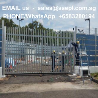 Construction site: tall metal gate being installed, workers in hard hats, ladder nearby; contact info overlay in the sky lightening colors.