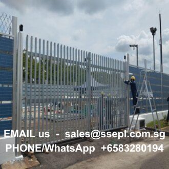 Construction site with a tall metal fence; a worker on a ladder near the gate; contact info overlay: sales@ssepl.com.sg and +6583280194.