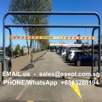Parking lot entrance with a metal barrier across the road and a Low Clearance sign; white text overlay shows email sales@ssepl.com.sg and phone +65 8328 0194.