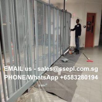 Technician standing near rows of tall metal server racks in a hallway; white text overlay shows contact email and WhatsApp/phone number.