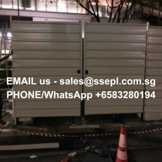 Nighttime construction-site barrier with white text displaying contact info: 'EMAIL us - sales@ssepl.com.sg' and 'PHONE/WhatsApp +6583280194'
