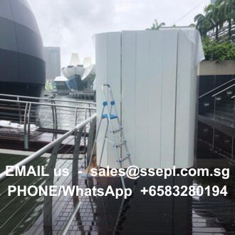 White outdoor cabinet on a dock with a ladder; contact info reads: EMAIL us sales@ssepl.com.sg, PHONE/WhatsApp +65 8328 0194.